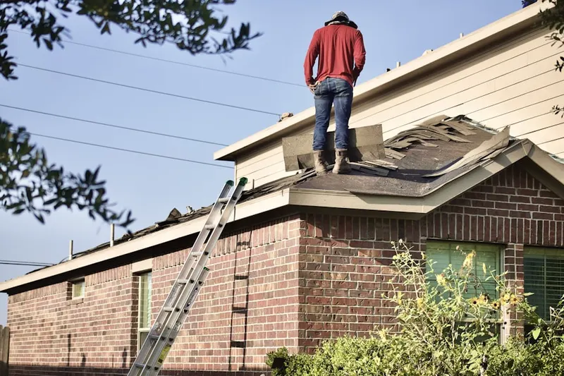 Professional roofer working on a residential roof in Laguna Canyon